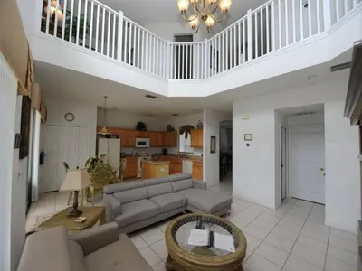 a living room with a couch and a table at Sunset Bliss Escape by Paradise Resort Vacations in Kissimmee