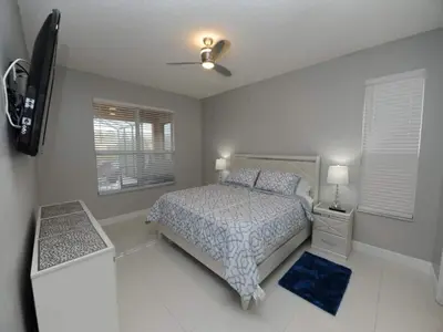 a bedroom with a bed and a ceiling fan at Sunshine Oasis Villa by Paradise Resort Vacations in Kissimmee