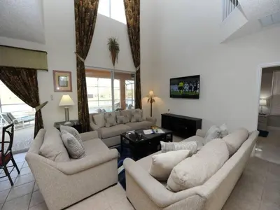 a large living room with couches and a tv at Sunshine Oasis Villa by Paradise Resort Vacations in Kissimmee