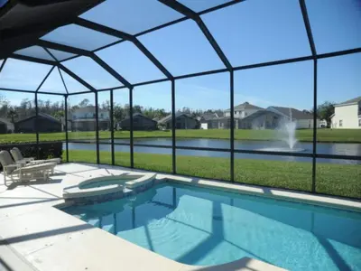a swimming pool in a house with a large glass wall at Ruby-rose Retreat in Kissimmee