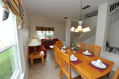 a dining room and living room with a table and chairs at Ruby-rose Retreat in Kissimmee