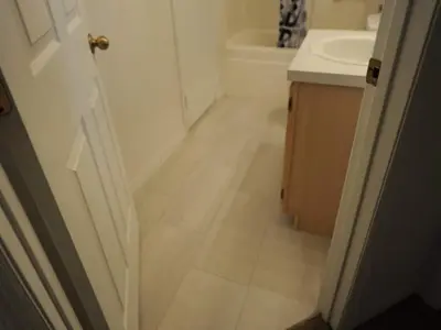 a bathroom with a toilet and a sink and a door at Palmview Villa by Paradise Resort Vacations in Orlando