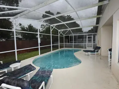 a large swimming pool with chairs and an overheadilion at Palmview Villa by Paradise Resort Vacations in Orlando