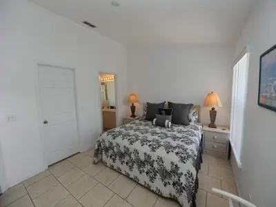 a bedroom with a bed with a black and white comforter at Holiday Hideout in Orlando