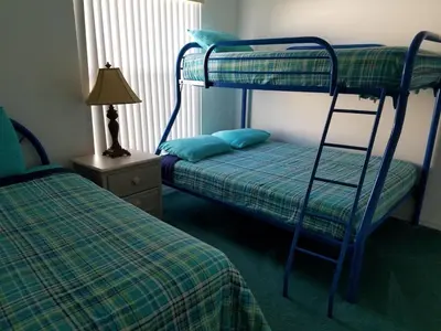 a bedroom with two bunk beds and a lamp at Holiday Hideout in Orlando