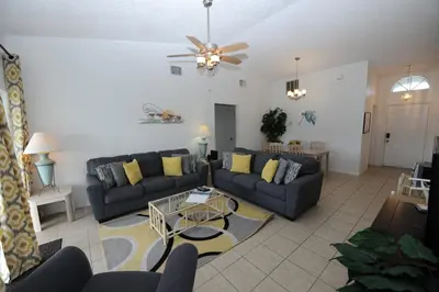 a living room with a couch and a table at Holiday Hideout in Orlando