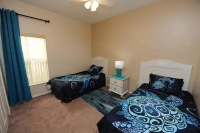 a bedroom with two beds and a window at Tranquil Waters Haven in Kissimmee