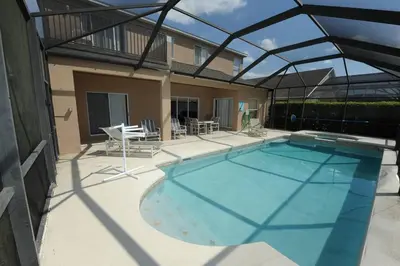 a large swimming pool with a roof at Tranquil Waters Haven in Kissimmee