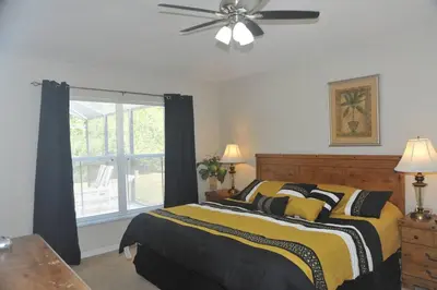 a bedroom with a bed and a ceiling fan at Serenity Retreat Near Disney in Kissimmee