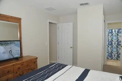 a bedroom with a bed and a dresser and a mirror at Serenity Retreat Near Disney in Kissimmee