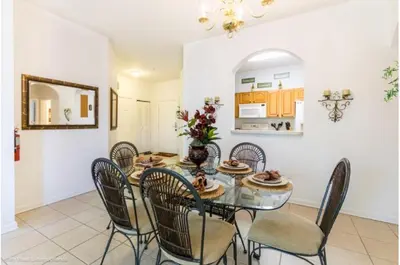 a dining room with a table and chairs at Three-Bedroom Apartment Kissimmee in Orlando