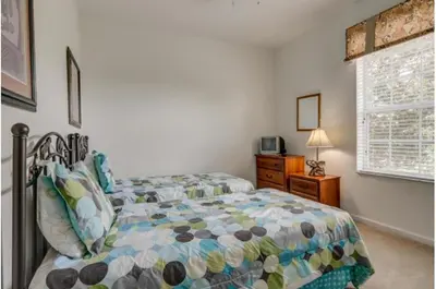 a bedroom with a bed and a window at Three-Bedroom Apartment Kissimmee in Orlando