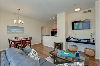 a living room with a couch and a table at Two-Bedroom Townhome Kissimmee in Orlando