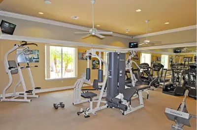 a gym with treadmills and ellipticals in a house at Four-Bedroom Townhome Kissimmee in Orlando