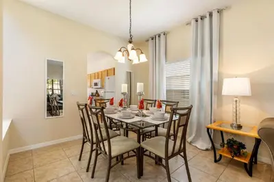 a dining room with a table and chairs at Five-Bedroom Pool Home Kissimmee in Orlando