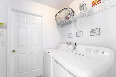 a white laundry room with a washer and dryer at Near Disney Private Pool 4 Bedrooms in Kissimmee