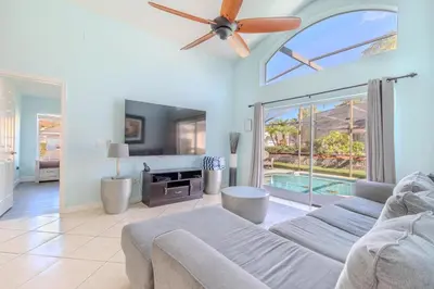 a living room with a couch and a ceiling fan at 4-Bed Home Near Disney Private Pool in Kissimmee