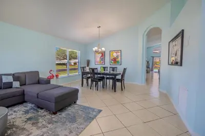 a living room with a couch and a table at 4-Bed Home Near Disney Private Pool in Kissimmee