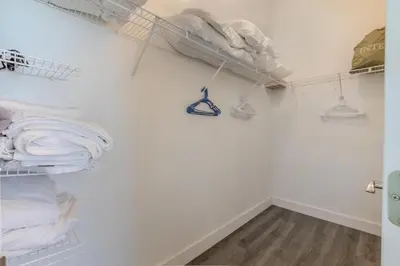 a room with white walls and shelves with towels at 4-Bed Home Near Disney Private Pool in Kissimmee