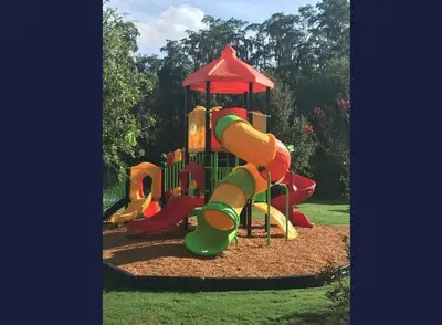a playground with a slide in a park at 4-Bed Home Near Disney Private Pool in Kissimmee