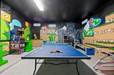 a play room with a ping pong table in it at 12BR Disney Home | Sleeps 30+, GameRoom, POOL/SPA! in Kissimmee