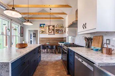 a kitchen with blue cabinets and a counter top at Cozy 3BR Retreat - Near Bars Zoo & Lake Trails in Sanford