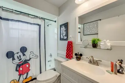 a bathroom with a toilet and a sink at Disney Getaway with Private Hot Tub 14 Mi to Parks in Kissimmee