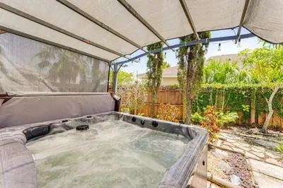 a hot tub in a backyard with a canopy at Disney Getaway with Private Hot Tub 14 Mi to Parks in Kissimmee