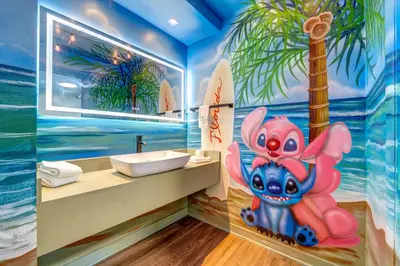 a bathroom with a painting of a pokemon at Surf and Sun Stitch Studio Kissimmee in Kissimmee