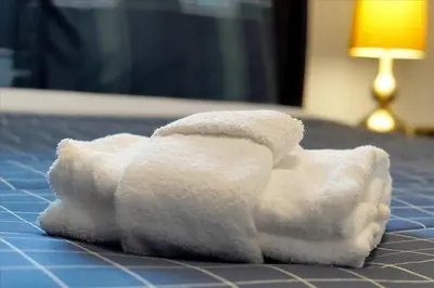 a white towel on top of a bed at Vista Cay Resort Minutes to Parks & Magic! in Orlando