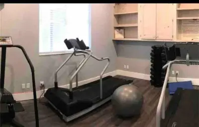 a room with a gym with a pilates ball on the floor at Condo Near Disney No Resort Fee Free Parking in Orlando