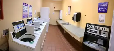 a bathroom with a row of sinks and toilets at Condo Disney Universal Epic Free Parking in Orlando