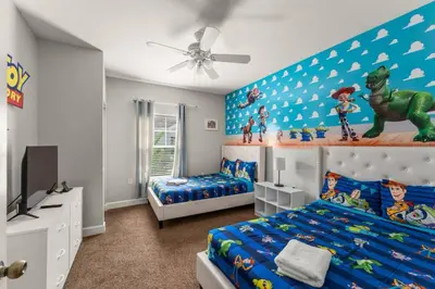 a bedroom with two beds and a dinosaur wall at Family 3BR near Disney -4102 in Kissimmee