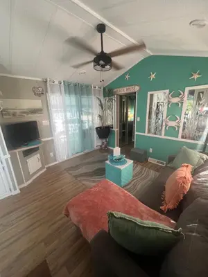 a living room with a couch and a table at Cozy Private Cottage Only 5 miles from Disney in Kissimmee