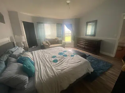 a bedroom with a large bed and a couch at Orlando 4 bedroom Family Retreat in Orlando