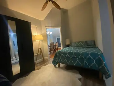 a bedroom with a bed and a ceiling fan at Orlando 4 bedroom Family Retreat in Orlando