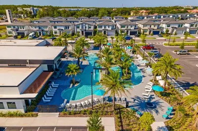 an aerial view of a resort with a pool and palm trees at Brand New 15 Bedrooms Single Family Paradiso 37SA in Orlando