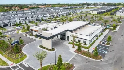 an aerial view of a building with a parking lot at Brand New 15 Bedrooms Single Family Paradiso 37SA in Orlando