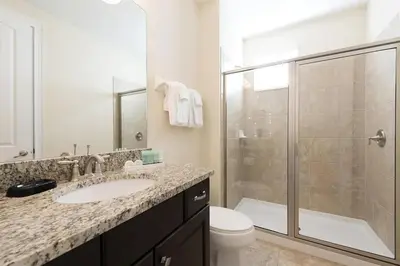 a bathroom with a sink and a shower and a toilet at Luxury 9-Bedroom Villa with Pool Near Disney in Orlando
