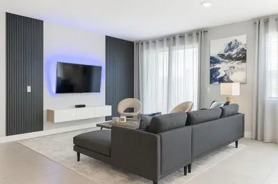 a living room with a couch and a tv at Casa Disney 5 Quartos c/ Piscina – 13 Pessoas in Kissimmee