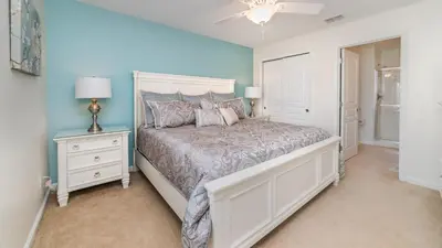 a bedroom with a white bed and a blue wall at Private 6 Bed 4 Bath Villa- Cozy family vacation home sleeps up to 12 guests in Orlando
