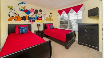 a bedroom with two beds with red sheets and a tv at Private 6 Bed 4 Bath Villa- Cozy family vacation home sleeps up to 12 guests in Orlando