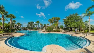 a swimming pool at a resort with palm trees at Private 6 Bed 4 Bath Villa- Cozy family vacation home sleeps up to 12 guests in Orlando