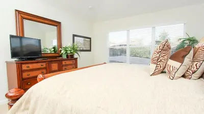 a bedroom with a bed with a television and a window at Urban 6 Bed 4 Bath Villa- Perfect stay while exploring Orlando,Florida in Orlando
