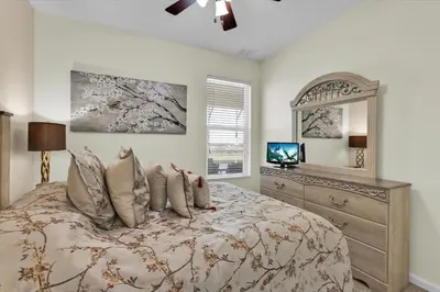 a bedroom with a bed with a dresser and a mirror at Urban 6 Bed 4 Bath Villa- Perfect stay while exploring Orlando,Florida in Orlando
