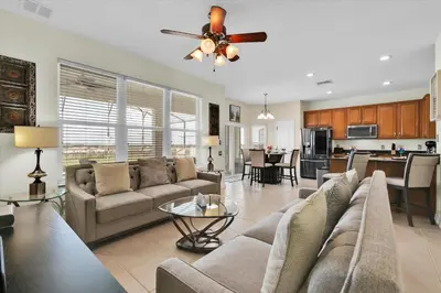 a living room with a couch and a ceiling fan at Urban 6 Bed 4 Bath Villa- Perfect stay while exploring Orlando,Florida in Orlando