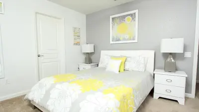a bedroom with a bed and two night stands and two lamps at Urban 6 Bed 4 Bath Villa- Perfect stay while exploring Orlando,Florida in Orlando