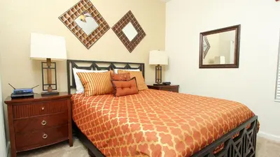 a bedroom with a bed and a dresser and a mirror at Urban 6 Bed 4 Bath Villa- Perfect stay while exploring Orlando,Florida in Orlando