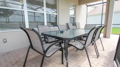 a black table and chairs on a patio at Urban 6 Bed 4 Bath Villa- Perfect stay while exploring Orlando,Florida in Orlando