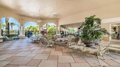 a lobby with chairs and tables and windows at Urban 6 Bed 4 Bath Villa- Perfect stay while exploring Orlando,Florida in Orlando